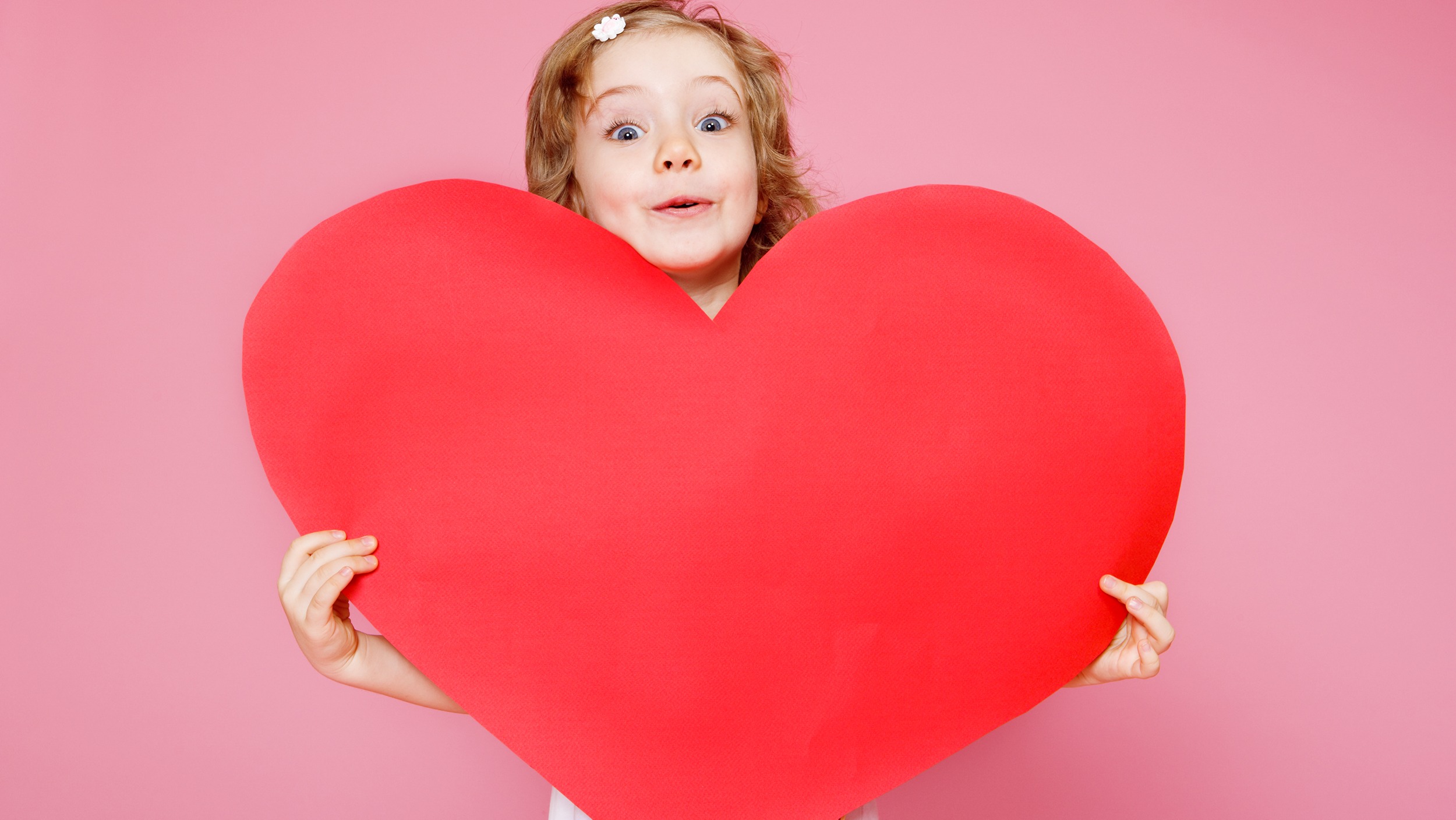 Child holding a large heart