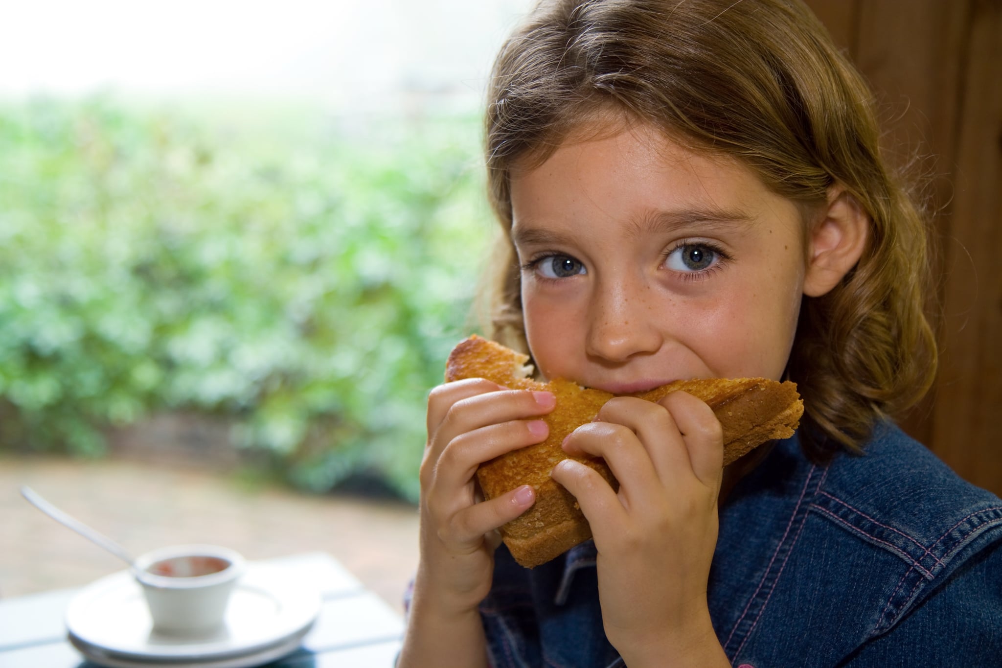 child eating sandwich