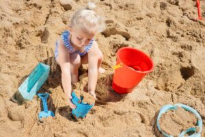 child playing in the sand