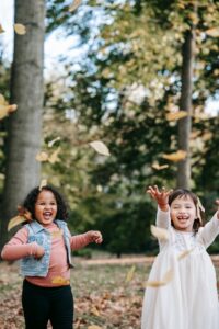 Girls playing leaves