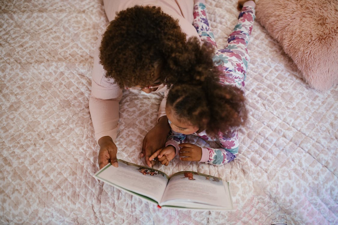 mom and child reading in bed