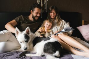 family in bed with dog