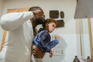 dad and child brushing teeth