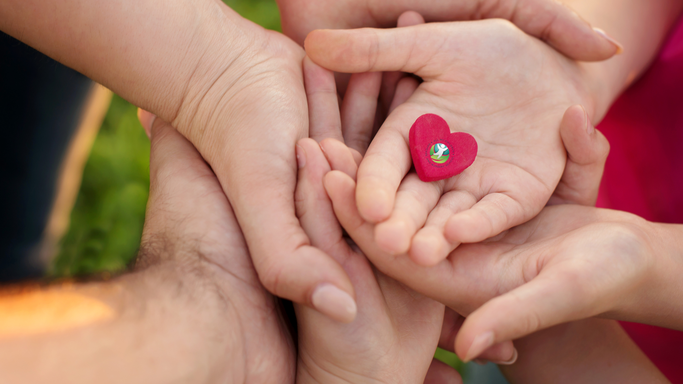 Hands joined together holding a heart to represent family relationship quality and well-being